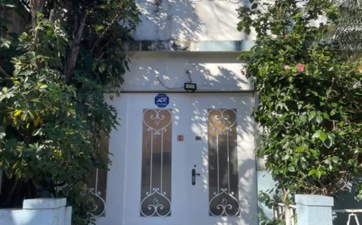 Frente de casa con el cerco y el cantero mantenidos